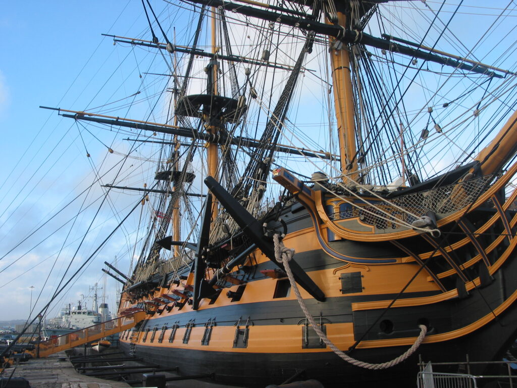 Nelson's flagship, HMS Victory, with a modern warship in the background